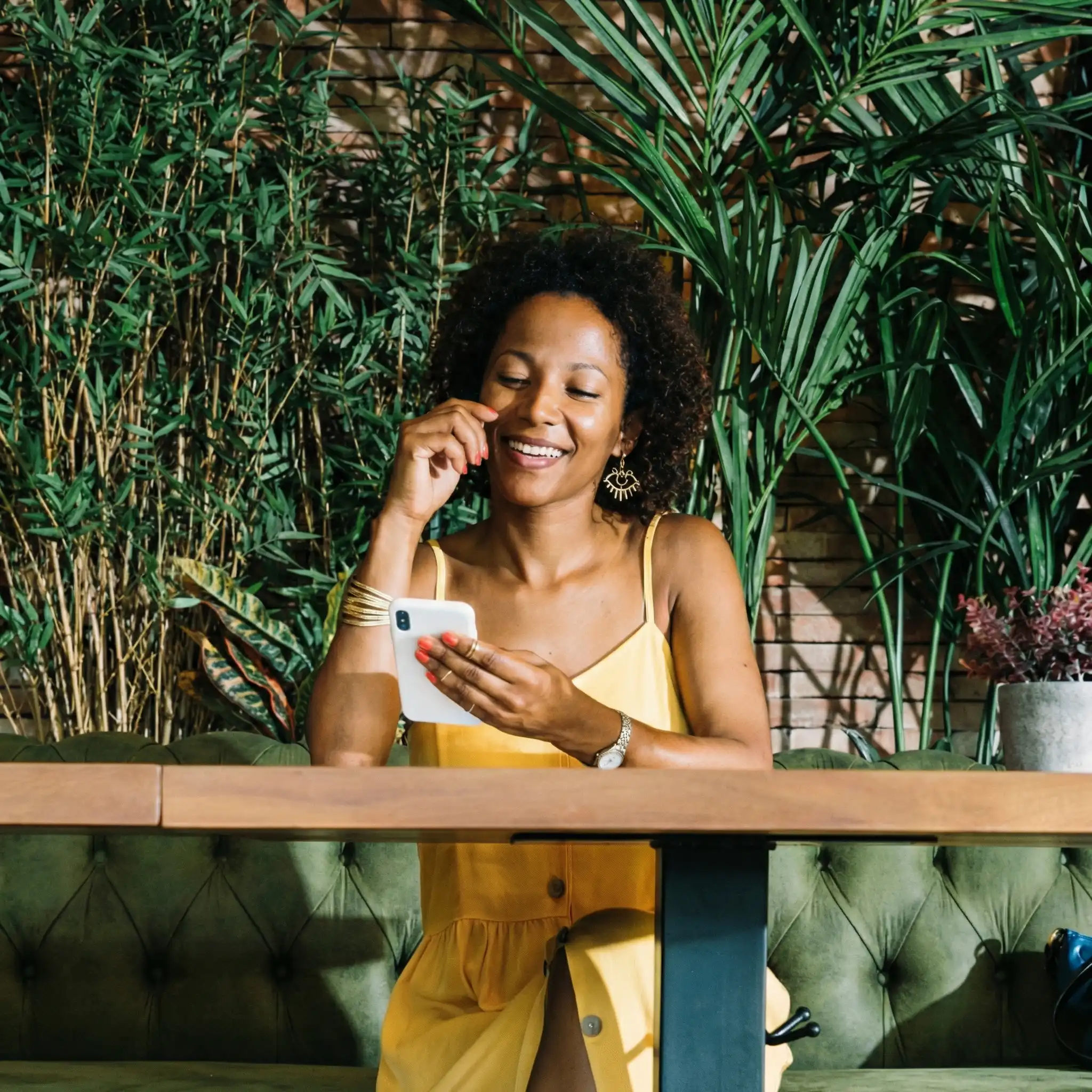 Woman using smartphone to send money home with PayAngel